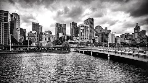 View of cityscape against cloudy sky