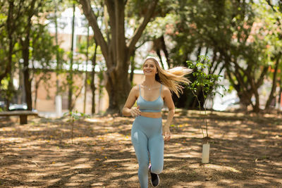 Woman running and jogging at a park outdoors. athlete female person during workout. healthy 