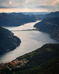 High angle view of sea and mountains against sky