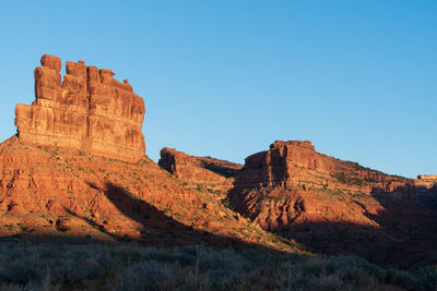 Landscape of red buttes against blue sky in the valley of the gods in utah