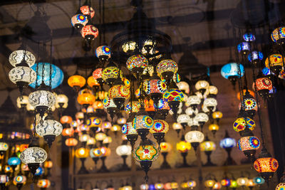 Illuminated lanterns hanging in store for sale at market