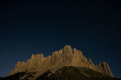 Low angle view of rock formations against sky at night