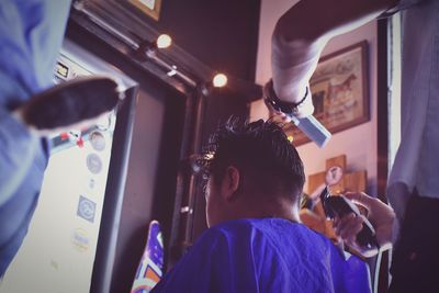 Midsection of barber cutting customer hair