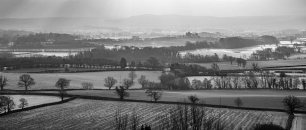 Scenic view of landscape against sky during winter