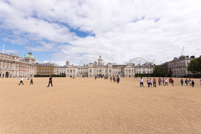 People at horse guards parade against sky