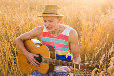 Man playing guitar on field