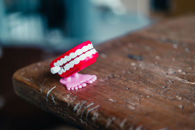 Close-up of red artificial denture on table