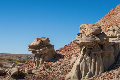 Bisti badlands landscape of strange hoodoos or rock formations on a small hill in new mexico