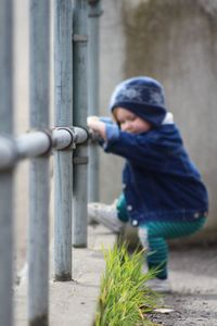 Side view of boy standing outdoors