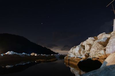 Scenic view of sea against sky at night