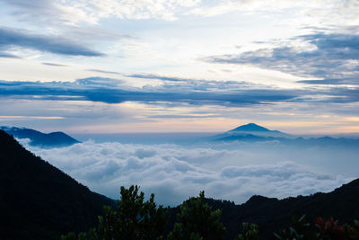 Scenic view of mountains against cloudy sky