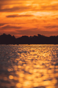 Surface level of silhouette land against sky during sunset