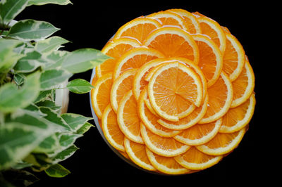 Close-up of orange slice over black background