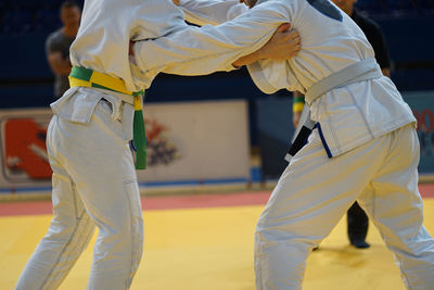 Midsection of people practicing martial arts