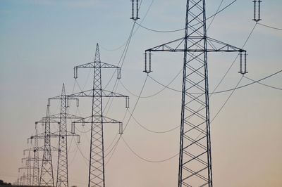 Low angle view of electricity pylon against sky