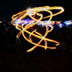 Close-up of illuminated ferris wheel at night