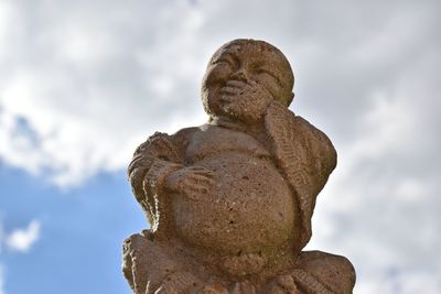 Low angle view of statue against sky