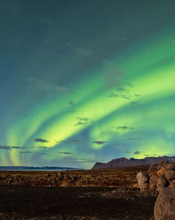 Scenic view of landscape against sky at night