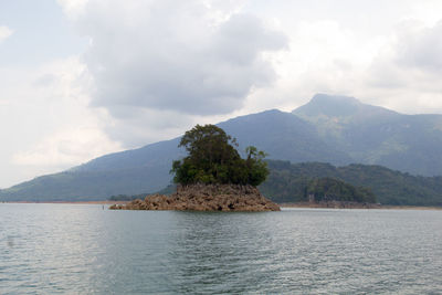 Scenic view of sea and mountains against sky