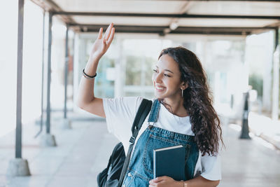 Portrait of smiling young woman using mobile phone