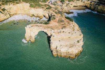 High angle view of rock by sea