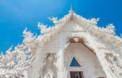 Low angle view of white building against blue sky