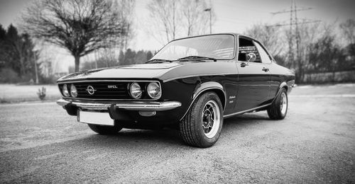 Close-up of vintage car parked on road