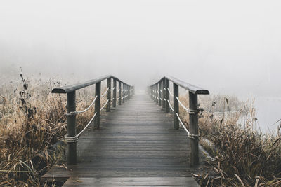 View of wooden bridge against sky