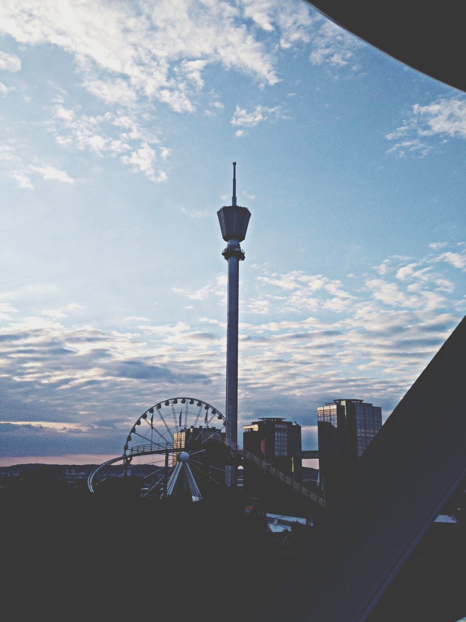 sky, architecture, built structure, cloud - sky, street light, building exterior, silhouette, cloud, city, tower, travel destinations, railing, lighting equipment, water, cloudy, communications tower, travel, tall - high, outdoors, tourism