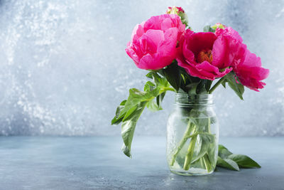 Close-up of pink roses in vase on table