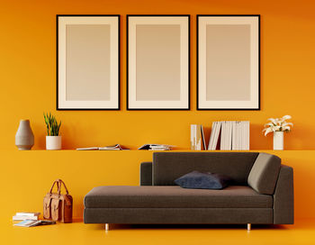 Modern yellow living room with sofa and furniture and group of picture frame on the wall. 3d render.