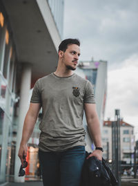 Young man standing in city