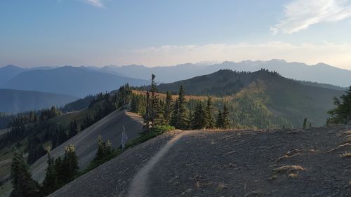 Road by mountains against sky