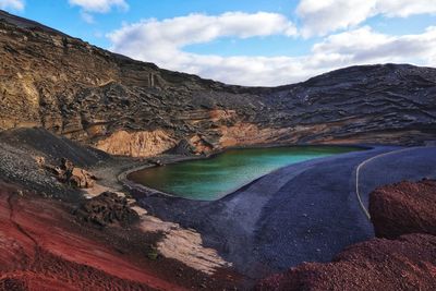 Scenic view of lake and mountains against sky, charco de los clicos, lanzarote, canary islands. 