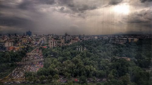 High angle view of cityscape against storm clouds