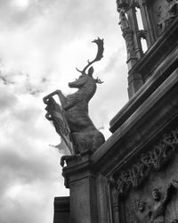 Low angle view of statue against cloudy sky