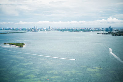 Aerial view of biscayne bay against cloudy sky