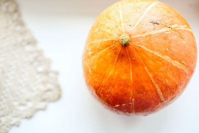 Close-up of pumpkin against orange background