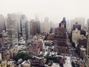 High angle view of buildings in city against sky