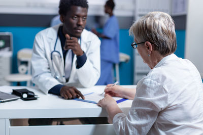 Doctor examining patient in clinic