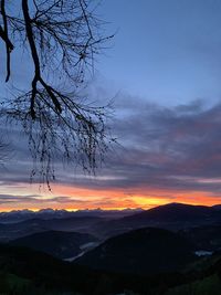 Scenic view of silhouette mountains against sky at sunset