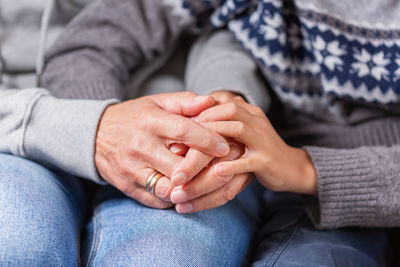 Senior woman and a child holding hands together. family, help, elderly care and support concept