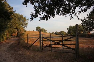 Fence on field against sky