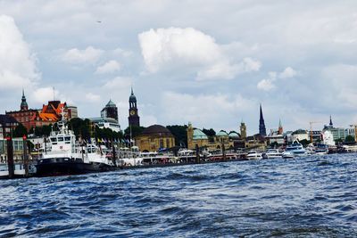View of harbor by sea against sky