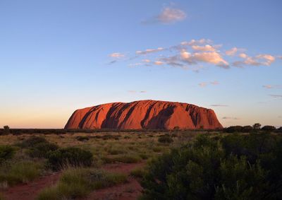 Scenic view of rocks on field against sky