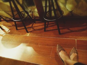 Low section of woman standing on tiled floor