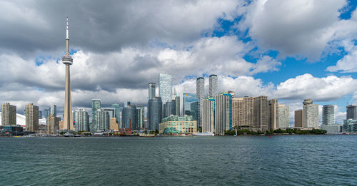 Panoramic view of buildings against cloudy sky