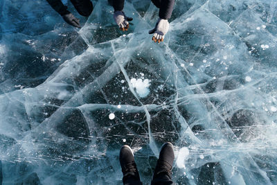 Low section of man standing on ice