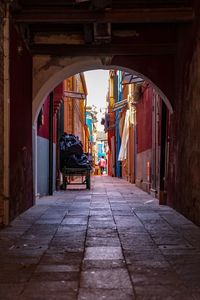 Empty alley amidst buildings in city