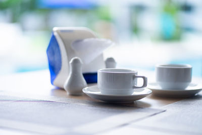 Close-up of coffee cup on table